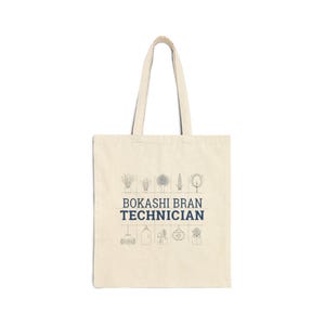 May include: A natural-toned tote bag with the navy blue text "BOKASHI BRAN TECHNICIAN". The design includes line drawings of plants and gardening tools. The bag has two handles for carrying.