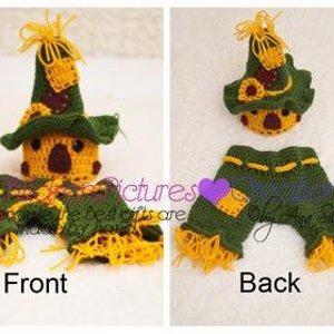 May include: A crocheted scarecrow costume for a baby, featuring a green and yellow hat with a brown face and a green and yellow jumpsuit with frayed edges.