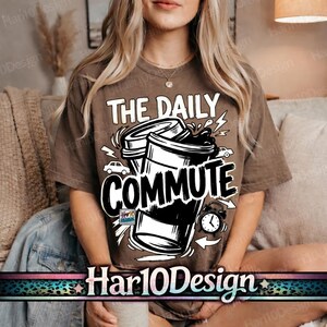 May include: Brown t-shirt with the text "THE DAILY COMMUTE" in white, featuring coffee cups, cars, and an alarm clock graphic. The shirt is a casual wear item.