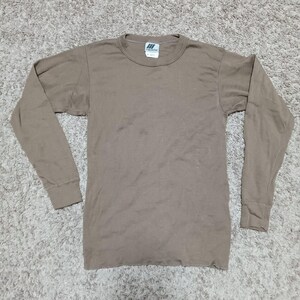 May include: A white ceramic mug with a black handle and the text "But First, Coffee" in a black, bold font. The mug is sitting on a wooden surface. The mug is 4 inches tall.