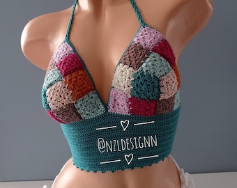 May include: A teal crochet halter top with a patchwork design in shades of pink, brown, orange, and green. The top has a V-neckline and is tied at the back. The text "@NZLDESIGNN" is printed on the front of the top.