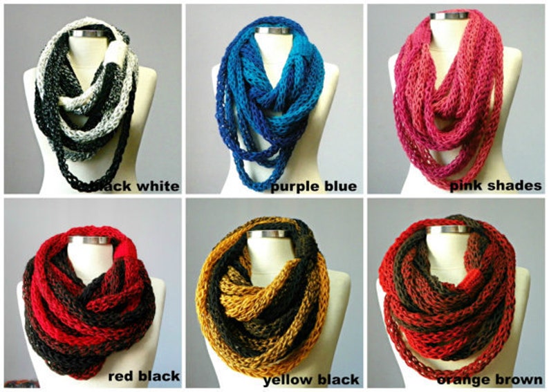 May include: Six infinity scarves in different color combinations. The scarves are made of a chunky yarn and are shown on a mannequin. The colors are black and white, purple and blue, pink shades, red and black, yellow and black, and orange and brown.