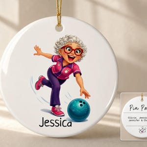 May include: A round white ceramic ornament featuring a cartoon illustration of a person with curly gray hair and red glasses bowling. The name Jessica is printed below. The reverse side displays the text Pin Pals with the names Olivia, Jessica, Amy, Jennifer & Charlotte.