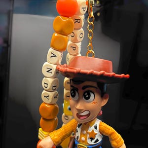 May include: A set of three ceramic mugs with a speckled, matte finish. The mugs are in cream, light grey, and dark grey. Each mug has a simple, minimalist design and a rounded handle.