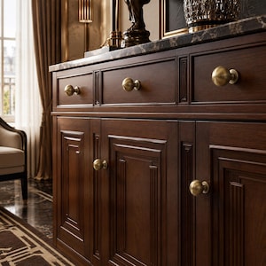 May include: A dark brown wooden sideboard featuring a marble top, three upper drawers, and three lower cabinet doors. Each drawer and door is accented with a round, brushed brass knob. The wood grain is visible, and the cabinet doors feature recessed rectangular paneling with vertical trim details.