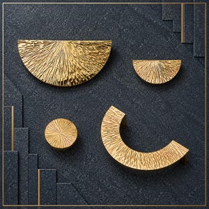 May include: A collection of four gold-toned metal cabinet hardware pieces featuring a textured, sunburst-like pattern. The set includes one large semi-circle, one small semi-circle, one circular knob, and one curved, arch-shaped handle.