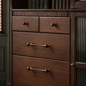 May include: A dark brown wooden cabinet featuring two small top drawers with round knobs, two larger lower drawers with horizontal bar handles, and a side section with a vertical ribbed glass door panel, all showcasing a natural wood grain finish.