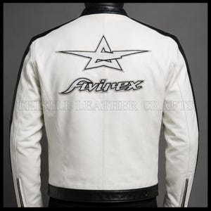 May include: White leather jacket with black accents on the shoulders, collar, and hem. The back features a star logo and the word "Avirex" in black, along with the text "Thistle Leather Crafts".