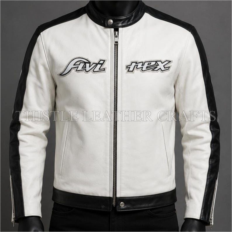 May include: White leather jacket with black accents on the shoulders and sleeves. The jacket has a stand-up collar, a full-length zipper, and the text "Fivi Rex" embroidered on the chest. The text "Thistle Leather Crafts" is printed at the bottom.