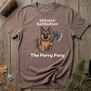 May include: A brown t-shirt featuring a cartoon German Shepherd dog holding an axe. The text "GERMAN BARBARIAN" is above the dog, and "The Furry Fury" is below. The shirt has a crew neck and short sleeves.