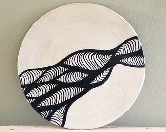 Ceramic plate, nearly black deep blue and white organic design. Waves and lines.