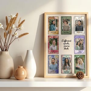 May include: A framed print displaying tarot cards with portraits. The cards are labelled with titles such as "The Star," "The Fool," and "The Moon." The text "Different cards, Same deck" is also visible. Decorative vases and a pinecone are on a white shelf.