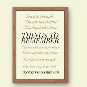 May include: A framed print with a cream-colored background and brown wooden frame. The print features inspirational text in black and gold fonts, including "THINGS TO REMEMBER" and "GENTLENESS IS STRENGTH."