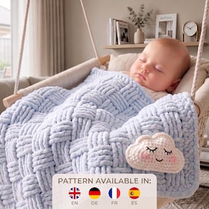 May include: A light blue chunky knit blanket with a woven texture, featuring a small, cream-colored crocheted cloud applique with a sleeping face. The blanket is draped over a sleeping infant in a hanging cradle. Text reads: PATTERN AVAILABLE IN: