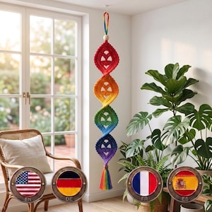 May include: A vertical hanging decoration featuring four interconnected, spiral-shaped crochet elements in a gradient of red, orange, green, blue, and purple. The piece includes a wooden bead at the top, a rainbow-colored loop, and a matching tassel.