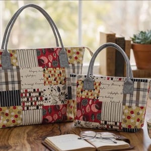 May include: Two tote bags featuring a patchwork design with red, cream, black, and olive green fabric squares. The bags have gray handles and a zipper closure. The patterns include floral motifs, stripes, and script text on a light background.