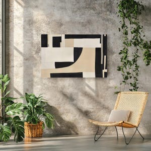 May include: A rectangular wall art piece featuring an abstract composition of bold black, white, and beige geometric shapes. The design consists of solid blocks and curved lines arranged in a balanced, non-representational layout on a flat surface.