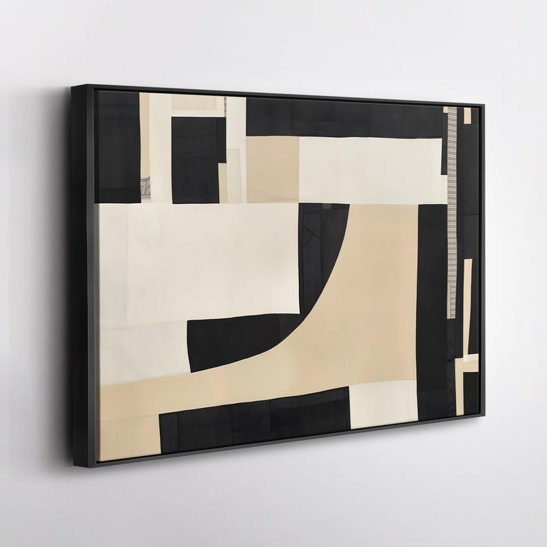 May include: A rectangular wall art piece featuring an abstract composition of geometric shapes in black, cream, and beige. The artwork is enclosed in a thin black frame and displays a series of solid blocks and curved lines arranged in a layered pattern.