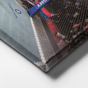 May include: A rectangular canvas print featuring a sports scene behind a black mesh net. The image includes a blue banner with the text "crypto.com" and a partial view of a red and white surface. The canvas has a textured fabric finish.
