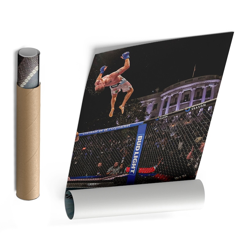 May include: A rolled poster featuring a photograph of a mixed martial arts fighter performing a backflip inside a cage. The background shows the White House at night. The cage structure includes blue padding with the text Bud Light and Polymarket.