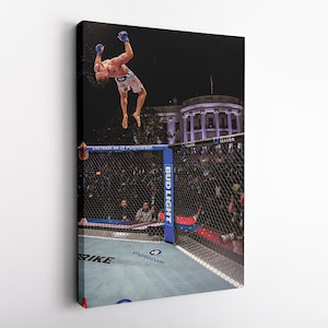 May include: A canvas print depicting a mixed martial arts fighter performing a backflip inside an octagon cage. The fighter wears blue gloves and patterned shorts. The White House is visible in the background. The cage features text including Polymarket, Bud Light, and crypto.com.