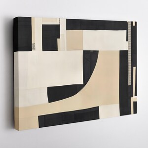 May include: A rectangular canvas wall art piece featuring an abstract composition of geometric shapes in black, cream, and beige. The design consists of solid blocks, vertical stripes, and curved forms arranged in a layered, non-representational layout.