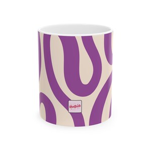 May include: A set of three ceramic mugs with a speckled, matte finish. The mugs are in shades of cream, light gray, and dark gray. Each mug has a simple, minimalist design, perfect for coffee or tea.