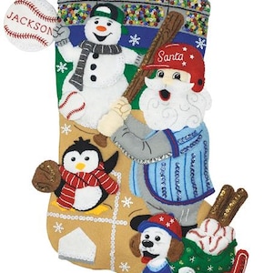 May include: Baseball-themed Christmas stocking with a snowman, penguin, Santa Claus, and a dog. The stocking has a baseball bat, baseballs, and a #1 foam finger. The baseball says "Jackson".