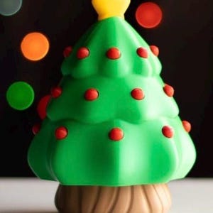 May include: A green Christmas tree-shaped decoration with red ornaments and a yellow star on top. The tree sits on a brown base, with a blurred background of colorful bokeh lights. Festive holiday decor.