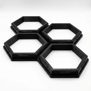 May include: A white ceramic mug with a black handle and the text "But First, Coffee" in a black, handwritten-style font. The mug is on a white surface.