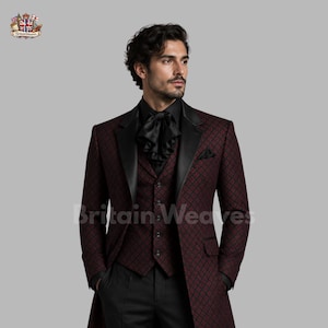 May include: A burgundy and black patterned suit with a long coat, vest, and black shirt. The suit has a geometric design and a black lapel. The shirt has a ruffled collar. The brand name "Britain Weaves" is visible.