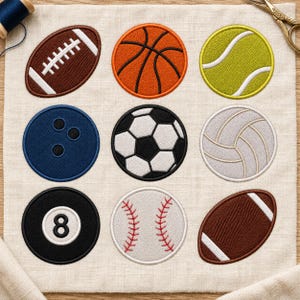 May include: An embroidered fabric square featuring nine circular and oval sports ball patches: a brown football, orange basketball, yellow-green tennis ball, blue bowling ball, black and white soccer ball, white volleyball, black eight ball, white baseball, and a brown football.