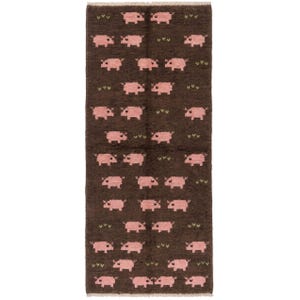 May include: A rectangular area rug featuring a dark brown background with a repeating pattern of small, light pink pig figures and tiny green V-shaped marks. The rug has a textured, woven appearance with a short fringe along the top and bottom edges.