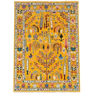 May include: A rectangular, golden-yellow rug with a detailed, colourful pattern. The design features a central tree motif with purple branches and a variety of floral and geometric elements in shades of pink, blue, and green. The rug has a decorative border.