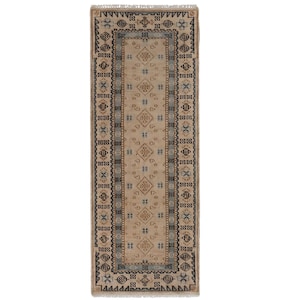 May include: A rectangular runner rug featuring a beige centre field with repeating geometric diamond motifs in brown and blue. The border consists of intricate dark brown and blue patterns on a beige background, finished with short white fringe.