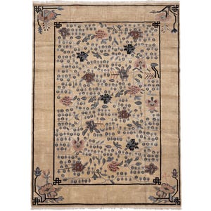 May include: A rectangular area rug with a tan background featuring a black border with geometric corner accents. The central field is decorated with a repeating pattern of small blue trees and scattered floral motifs in shades of pink and brown.