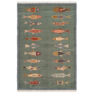 May include: A rectangular area rug in a muted sage green colour featuring a repeating pattern of stylised fish arranged in two vertical columns. Each fish displays a unique geometric design in shades of orange, blue, and cream. The rug has a dark blue border.