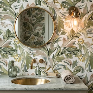 May include: A bathroom vanity featuring a round mirror with a gold frame, a brass faucet, and a gold-toned sink basin set into a marble countertop. The wall is covered in wallpaper with a green and beige botanical leaf pattern.