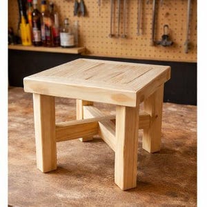 May include: A white ceramic mug with a black handle and the text "But First, Coffee" in a black, handwritten-style font. The mug is on a white surface.