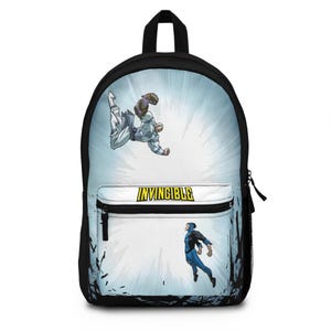 May include: A black backpack featuring a graphic print of the comic book series Invincible. The design shows two characters in mid-air combat against a light blue radial background. The word Invincible is printed in yellow on the front pocket.