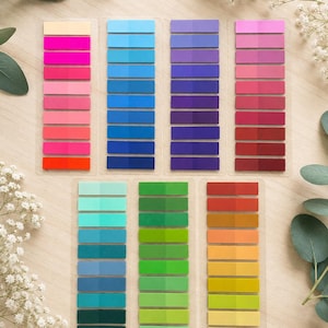 May include: A collection of seven transparent plastic sheets containing multiple rectangular adhesive page markers in a wide spectrum of colours, including shades of pink, blue, purple, red, green, orange, and yellow, arranged in vertical columns.