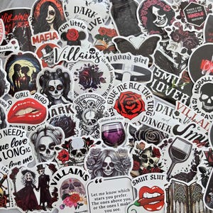May include: A collection of assorted stickers featuring dark romance and gothic themes, including illustrations of skulls, red roses, wine glasses, silhouettes, and text phrases like Villains, Smut Slut, and Girls Read Dirty Books.