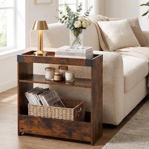 May include: A rectangular side table with a dark brown wood grain finish and black metal corner accents. The table features a flat top surface, a middle shelf, and a bottom storage compartment containing a woven basket filled with magazines.