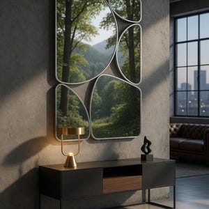 May include: A modern living room featuring a set of abstract-shaped mirrors with a forest view reflection. Below, a black console table with a gold lamp and a black sculpture. The room has a concrete wall and a large window.