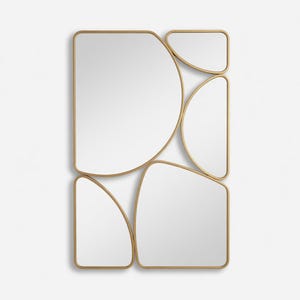 May include: A modern wall mirror with an abstract design. The mirror features multiple irregularly shaped panels with rounded edges, framed in a gold-colored metal. The arrangement creates a unique and artistic aesthetic.