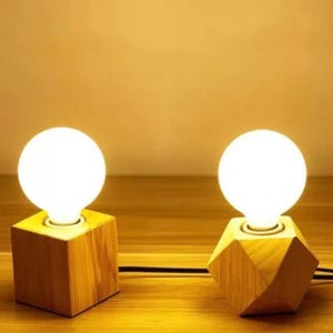 May include: A set of three ceramic mugs with a speckled, matte finish. The mugs are in shades of cream, light gray, and dark gray. Each mug has a simple, minimalist design, perfect for coffee or tea.