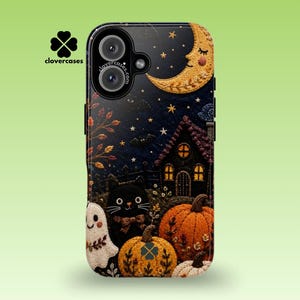 May include: A black smartphone case featuring an embroidered-style design of a night scene with a crescent moon, stars, a dark house, a black cat, a ghost, and orange pumpkins. The clovercases logo and text are visible on the upper left side.