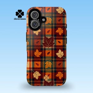 May include: A rectangular phone case featuring a dark red, orange, and green plaid pattern overlaid with scattered autumn maple leaves. The case includes a black camera module with two lenses and the text clovercases.com printed on the camera housing.