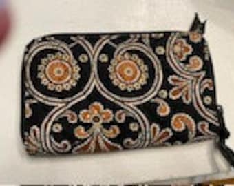 Vera Bradley Carry all,Black w carmel & white zippered around and has 1 outer zippered pocket 8 credit card and drivers license inside