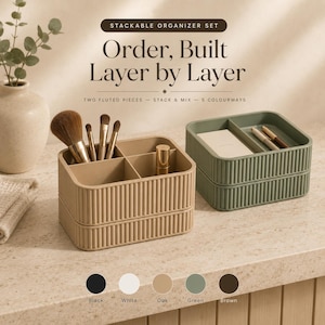 May include: A stackable organizer set with fluted sides, featuring a beige unit holding makeup brushes and a green unit holding pens. Text reads: STACKABLE ORGANIZER SET, Order, Built Layer by Layer, TWO FLUTED PIECES - STACK & MIX - 5 COLOURWAYS.